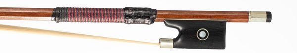A nickel-mounted violin bow, branded Tourte