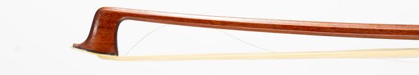 A nickel-mounted violin bow, faintly branded