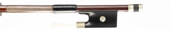 A nickel-mounted violin bow, branded Tourte