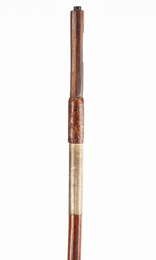 An un-mounted violin bow, branded Adam