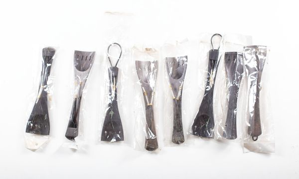 A bundle of eight cello tailpieces