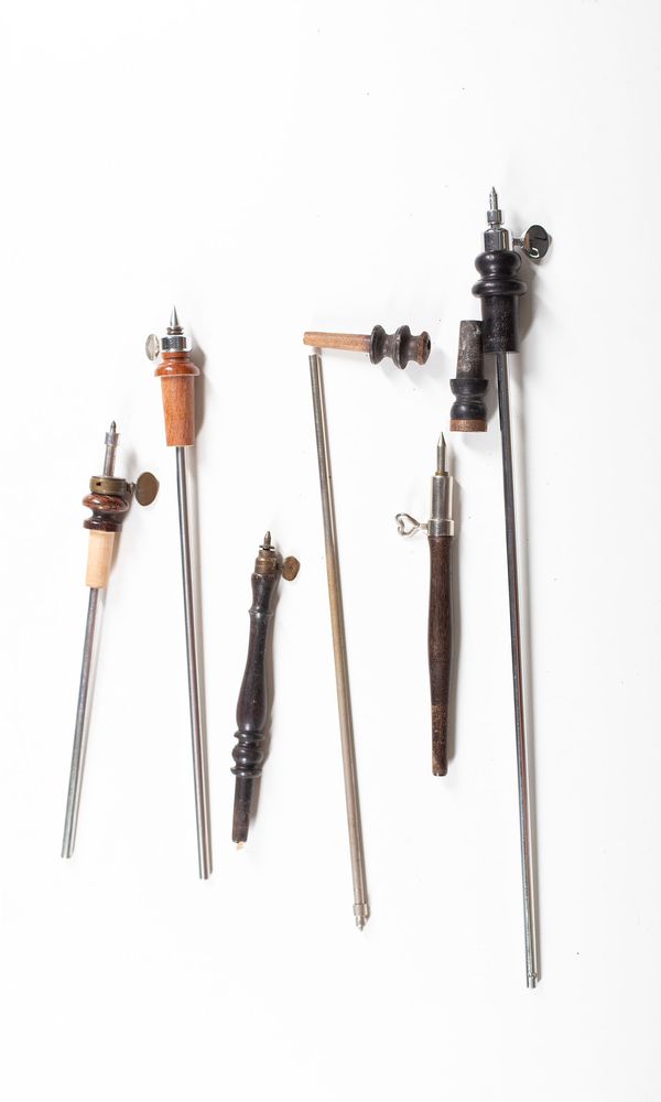 A bundle of cello endpins and rods, varying sizes