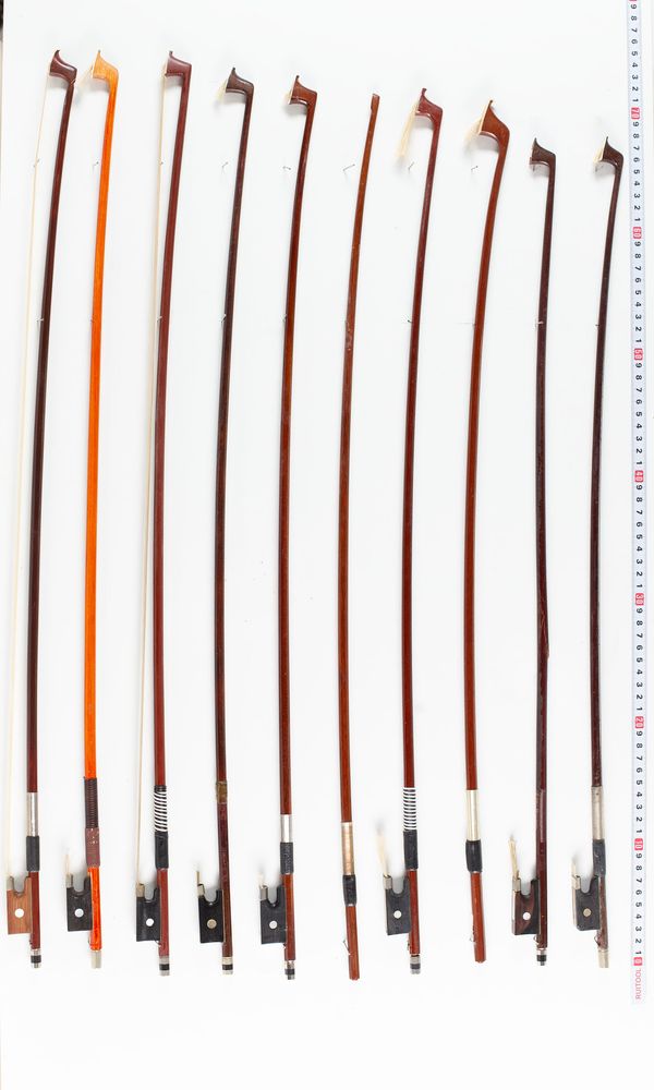 Fifteen violin bows, two cello bows and three sticks, varying lengths