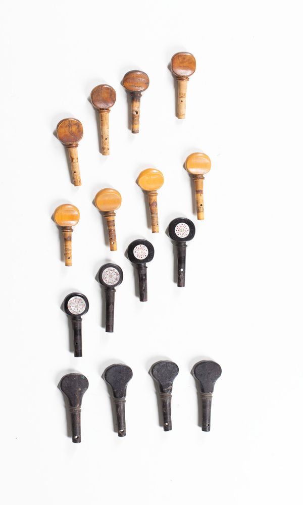 Four sets of violin pegs, varying sizes