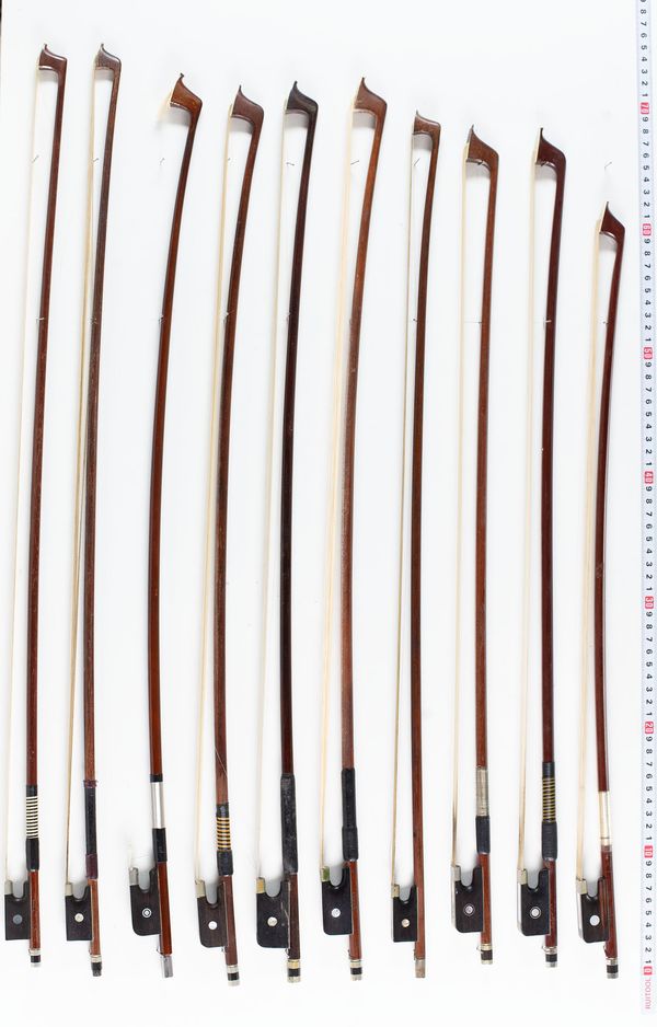 Fourteen cello bows and six violin bows, varying lengths