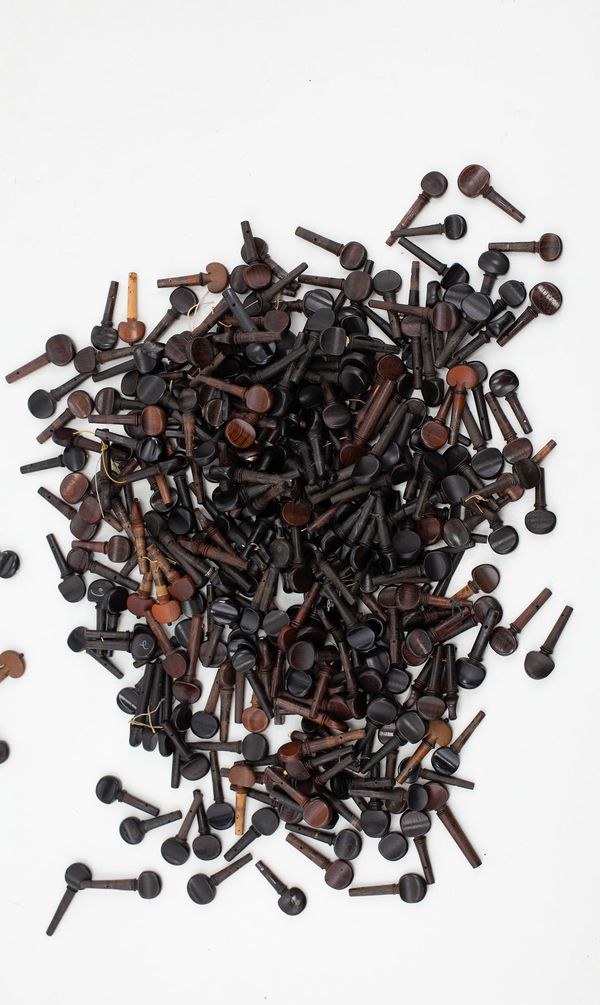 A box of violin and viola pegs, varying sizes