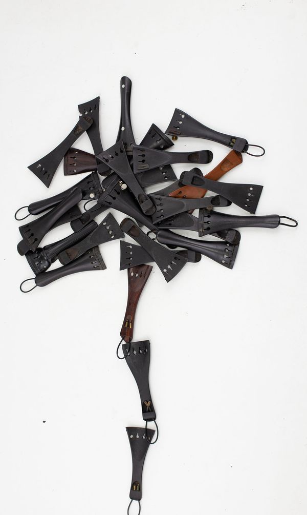 A box of violin tailpieces