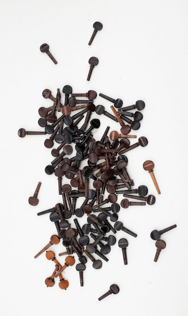 A box of violin and viola pegs, varying sizes