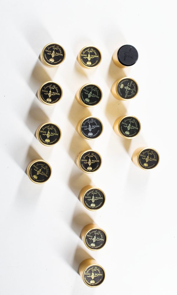 A bundle of fourteen bass rosins, branded Samuel Kolstein