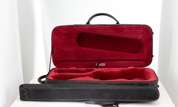 A violin case, branded Orly