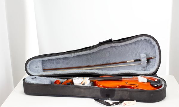 A three-quarter sized violin with bow and case