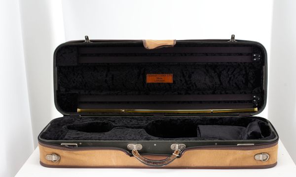 A violin case, branded Paxman