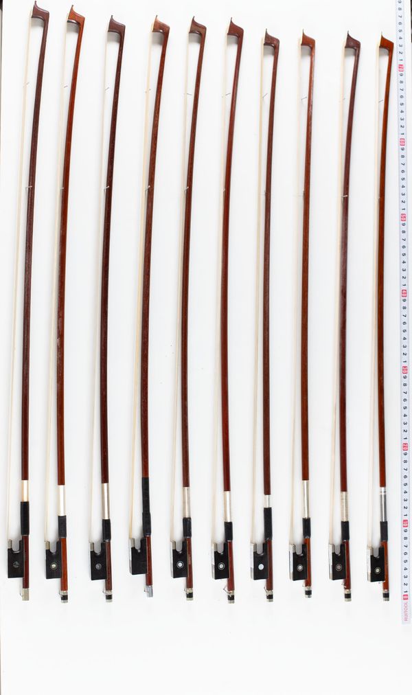 A bundle of ten violin bows, varying sizes