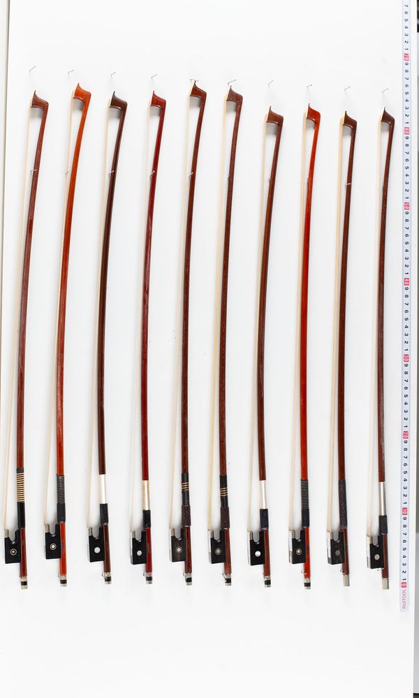 A bundle of ten 1/2 sized violin bows, varying sizes