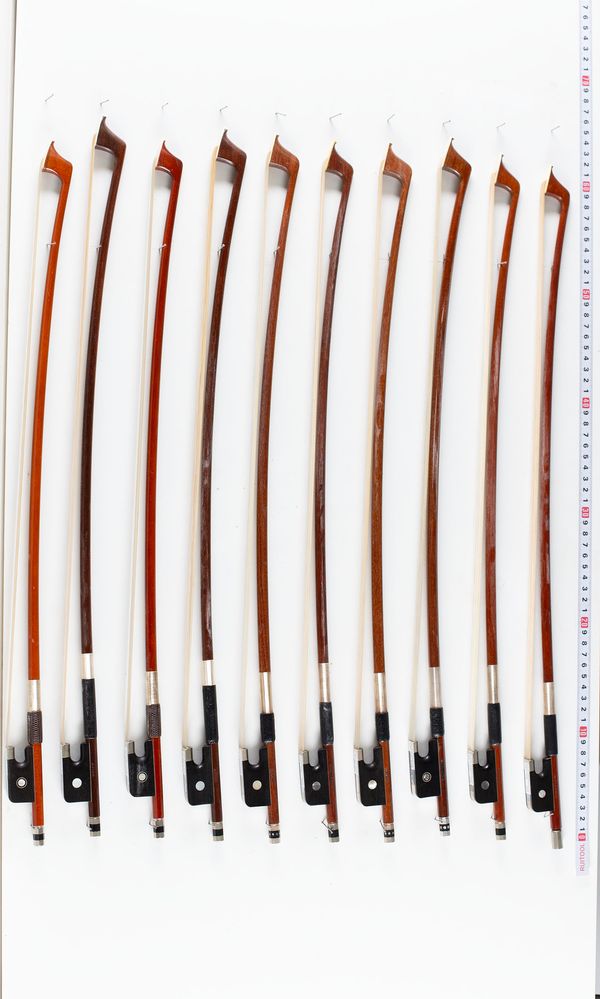 A bundle of ten 1/2 sized cello bows, varying sizes