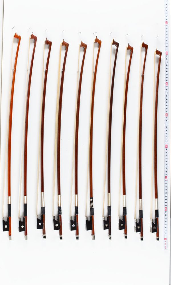 A bundle of eleven 1/2 sized violin bows, varying sizes