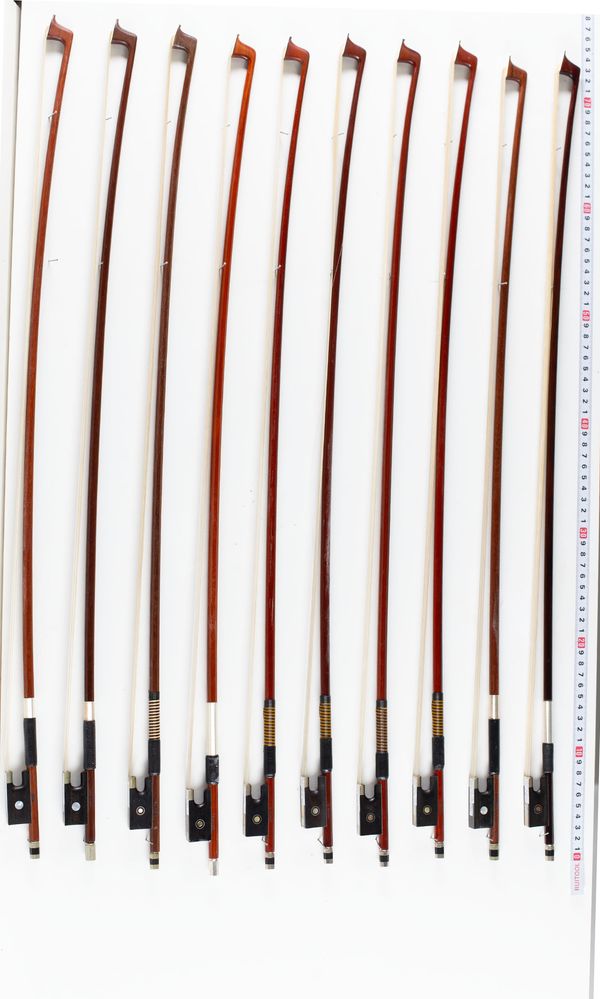 A bundle of ten violin bows, varying sizes