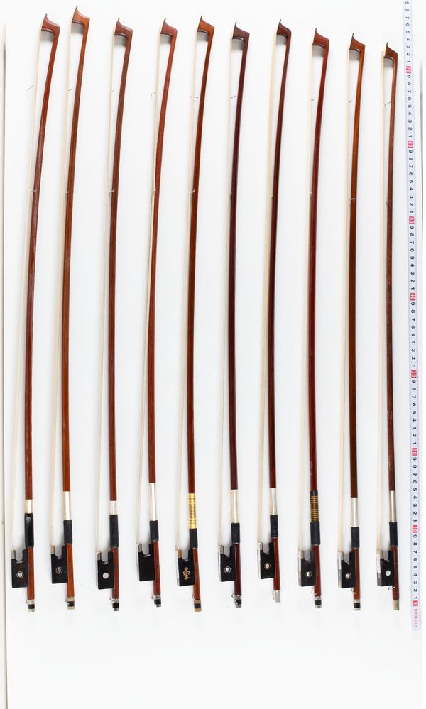 A bundle of fourteen violin bows, varying sizes
