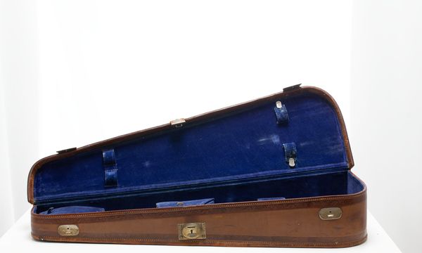 A violin case, branded Reliance