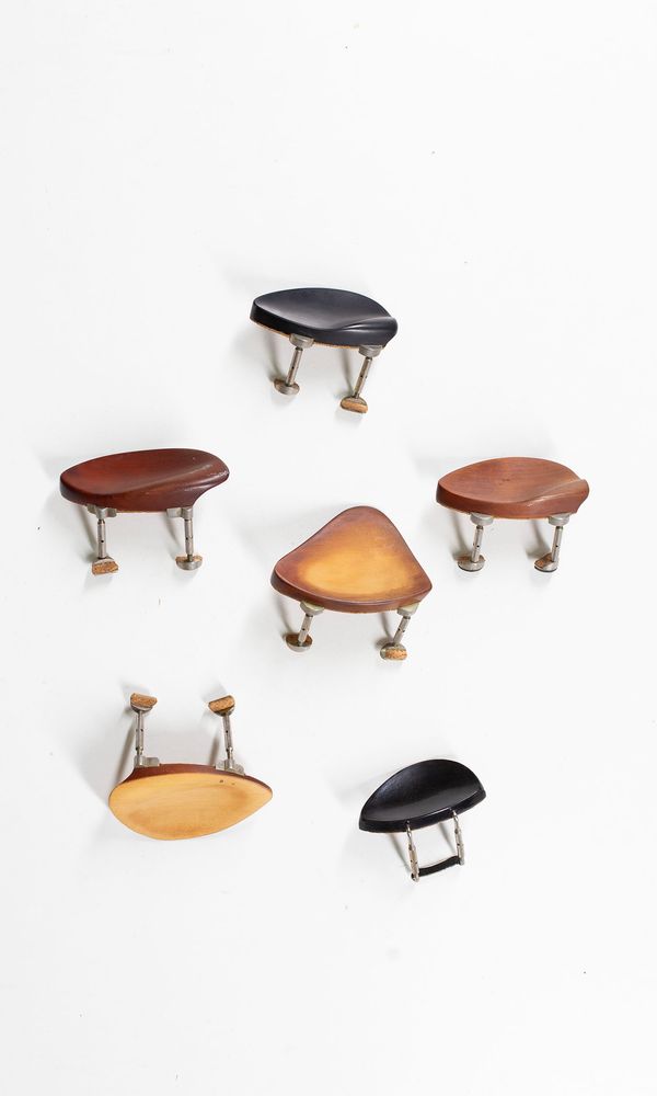 A bundle of six chinrests and two violin tailpieces