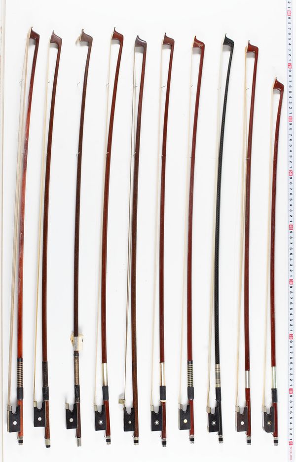 Ten violin bows and ten child-sized violin bows, various lengths