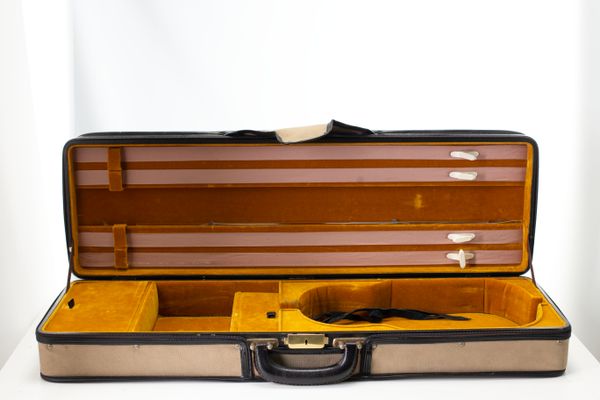 A violin case, branded Ealing Strings