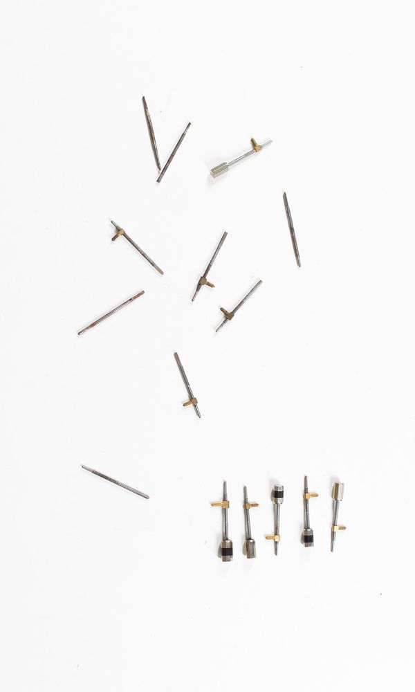 A bundle of cello bow adjusters and parts