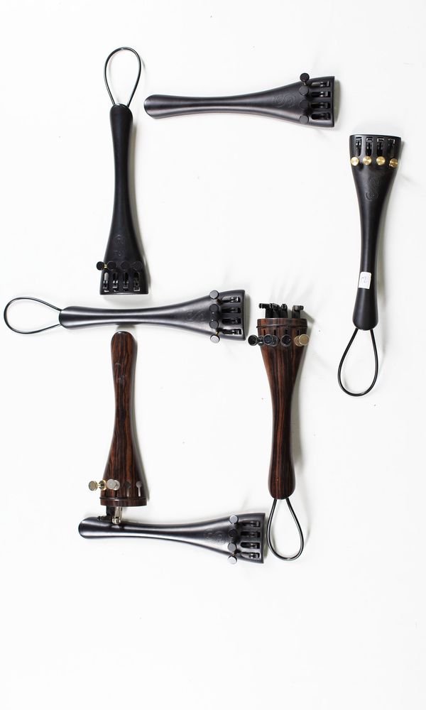 A bundle of fifteen cello tailpieces, varying sizes