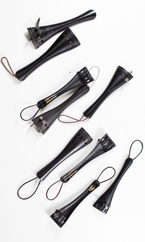 A bundle of fifteen cello tailpieces, varying sizes