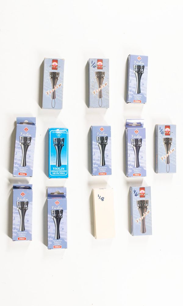 A bundle of ten 1/4 sized tailpieces and one 1/8 sized tailpiece