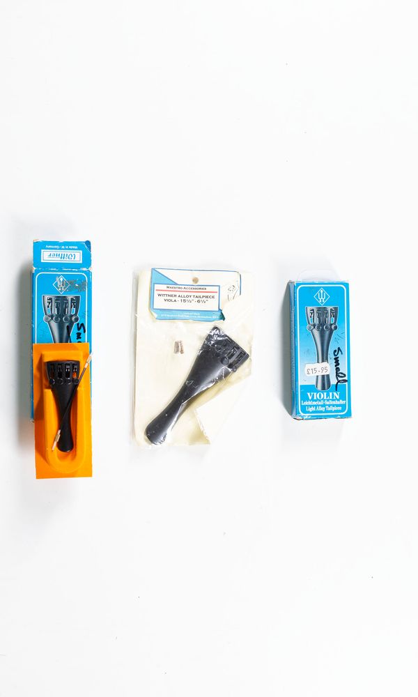 Two violin tailpieces and one viola tailpiece