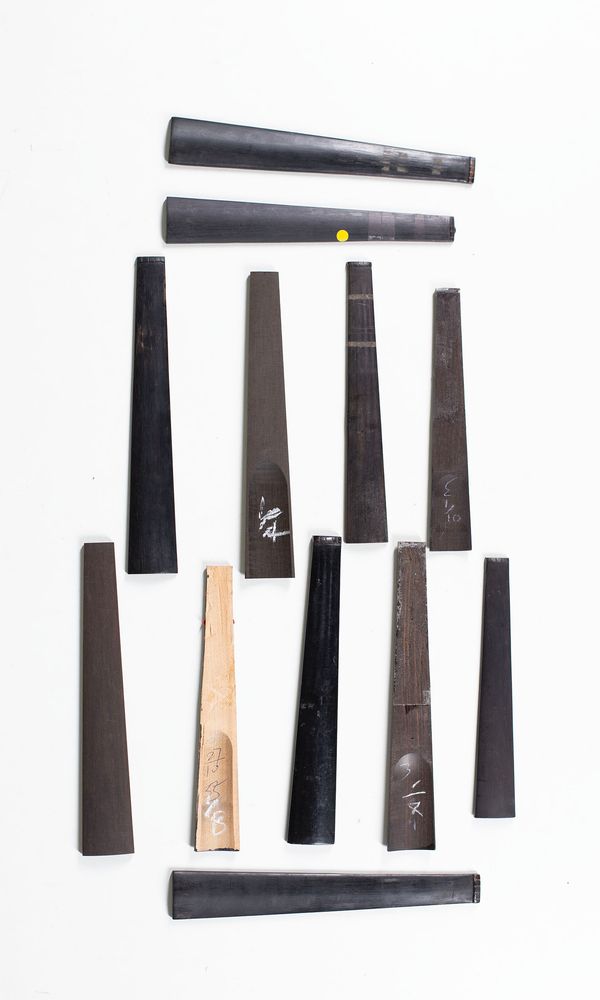 A bundle mixed sized  violin fingerboards