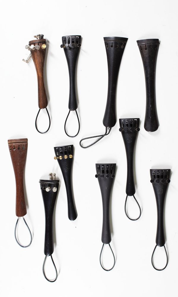 A bundle of fifteen cello tailpieces, varying sizes