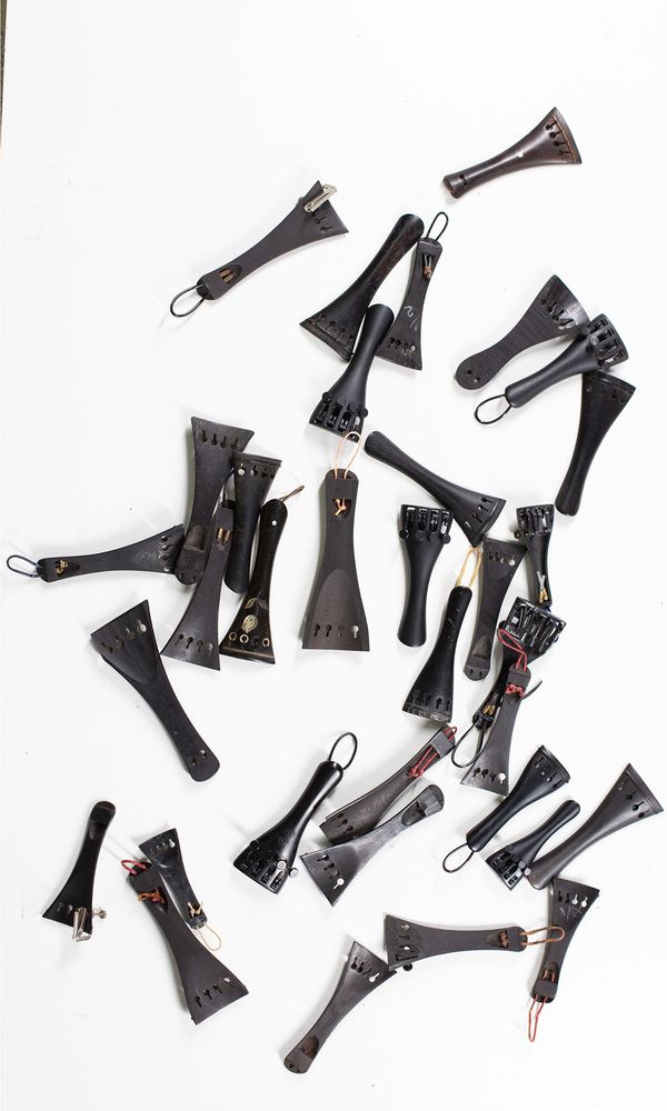 A bundle of thirty-four 1/2 sized violin tailpieces
