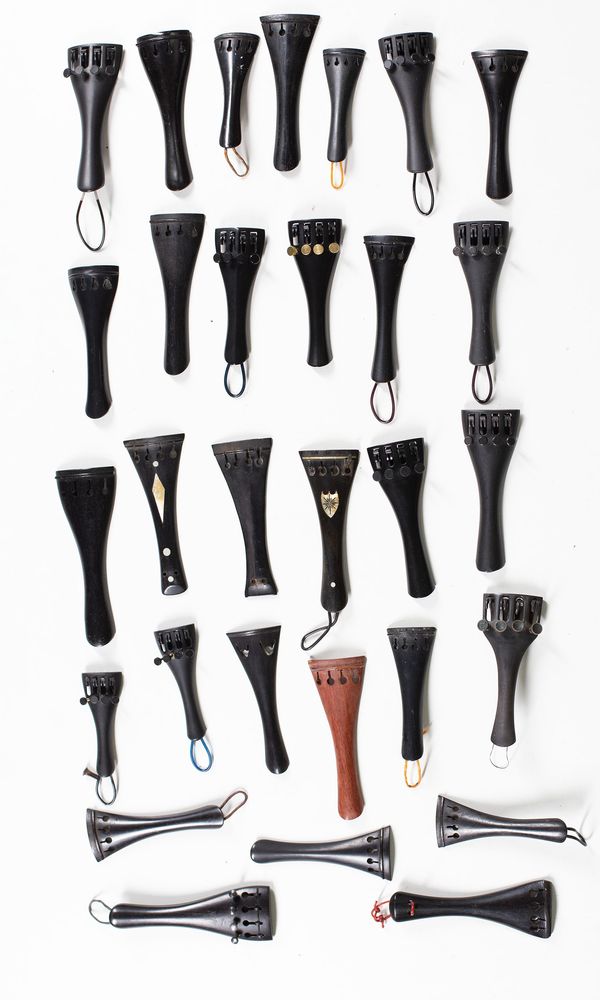 A bundle of thirty 1/2 sized violin tailpieces