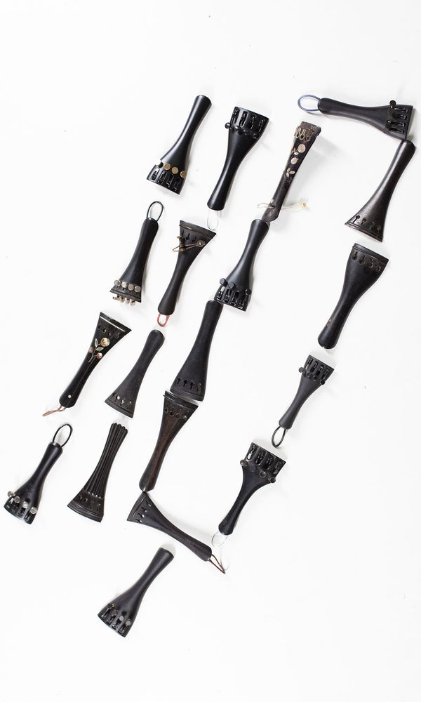 A bundle of thirty 1/2 sized violin tailpieces