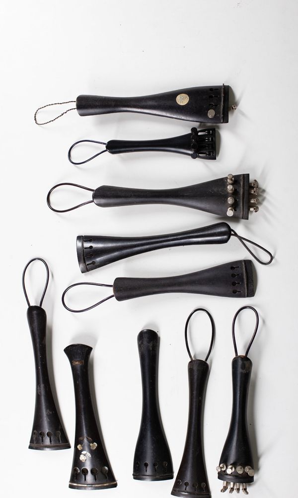 Twenty-one cello tailpieces, varying sizes