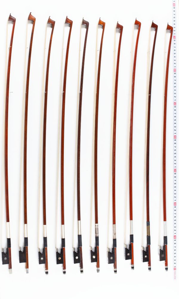 A bundle of twelve violin bows, varying sizes