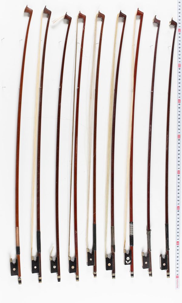 A bundle of nine violin bows, varying sizes