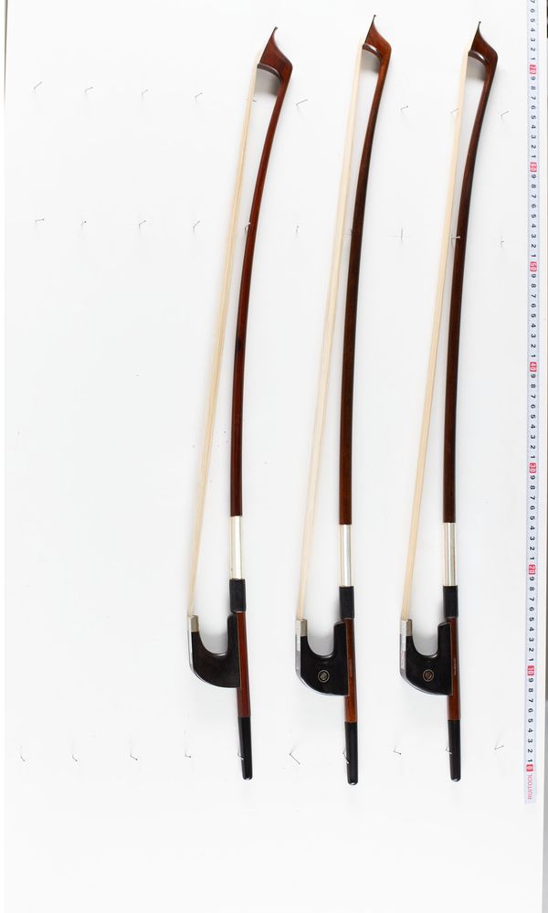 A bundle of three double bass bows, varying sizes