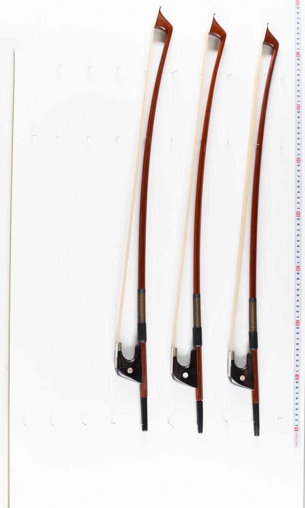 A bundle of three double bass bows, varying sizes