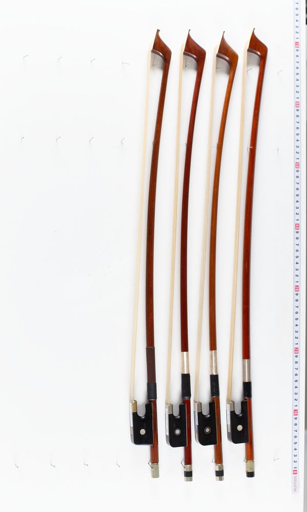 A bundle of four double bass bows, varying sizes