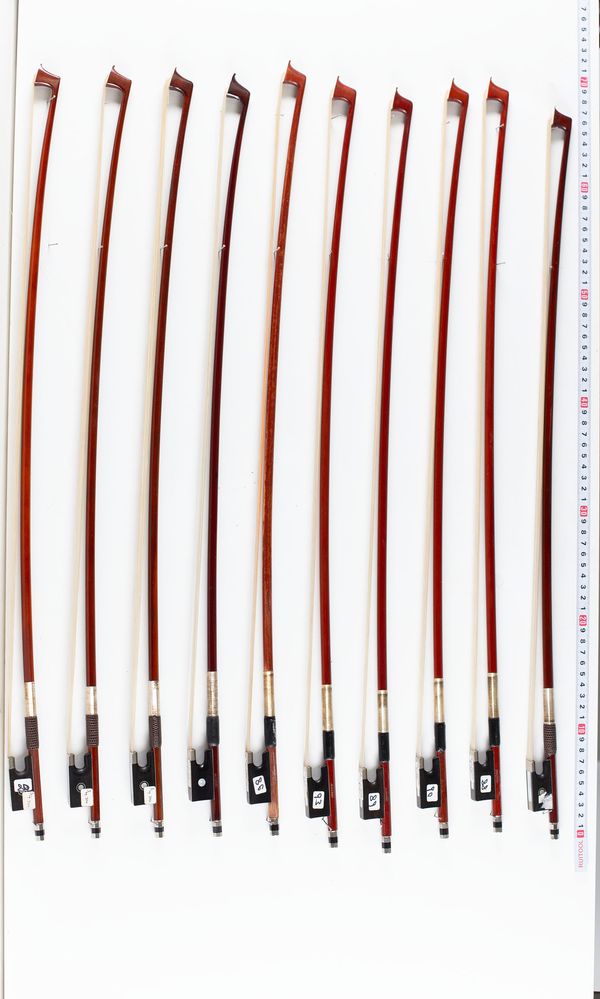 A bundle of twelve violin bows, varying sizes