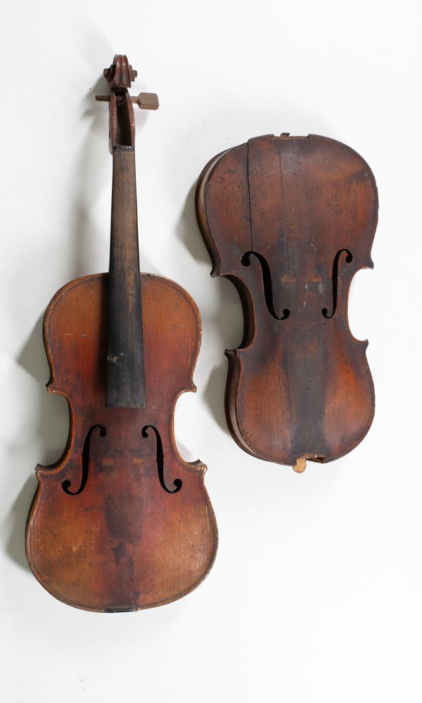 Three violins and one violin body, varying sizes