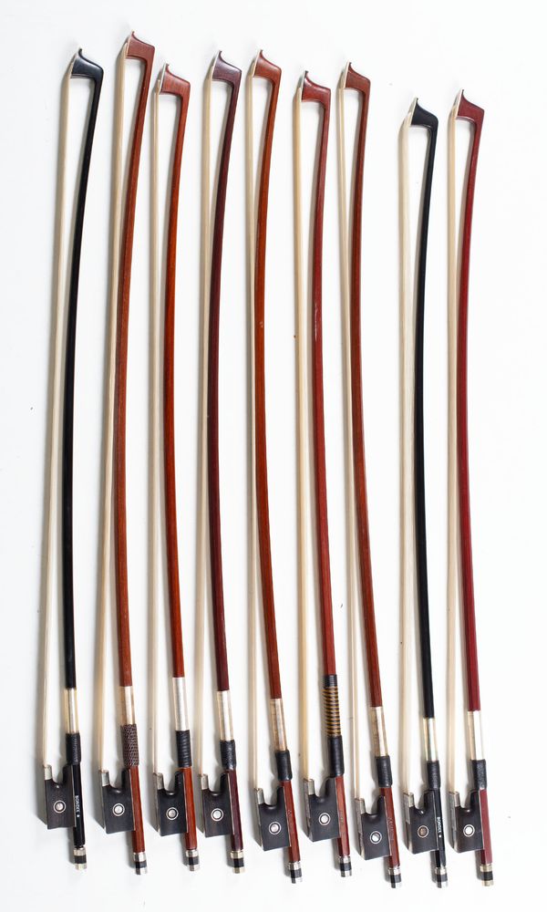 A bundle of nine 1/4 sized violin bows, varying sizes