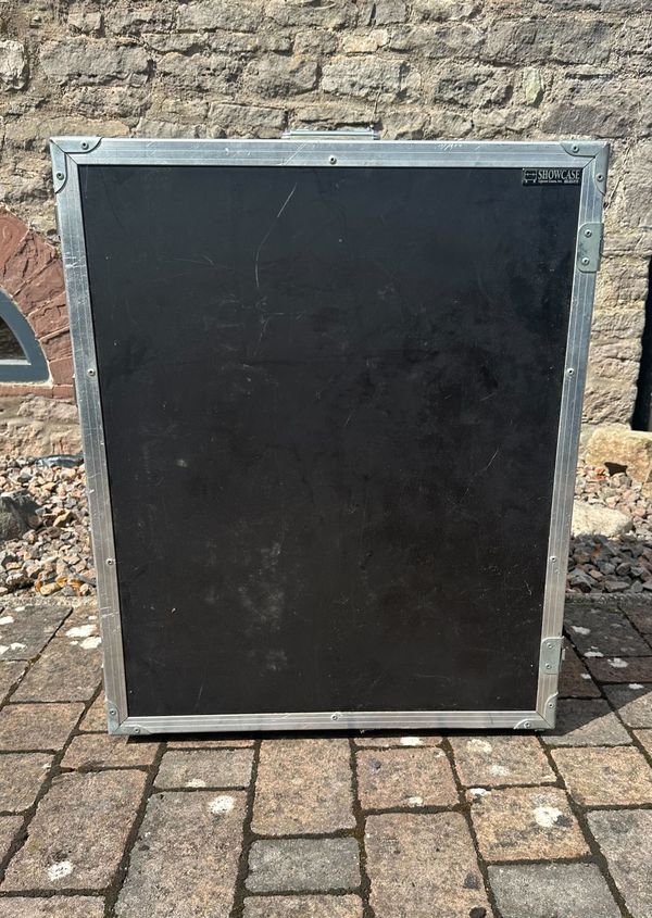 A large flight case for twelve violins and twenty-four bows, branded Showcase