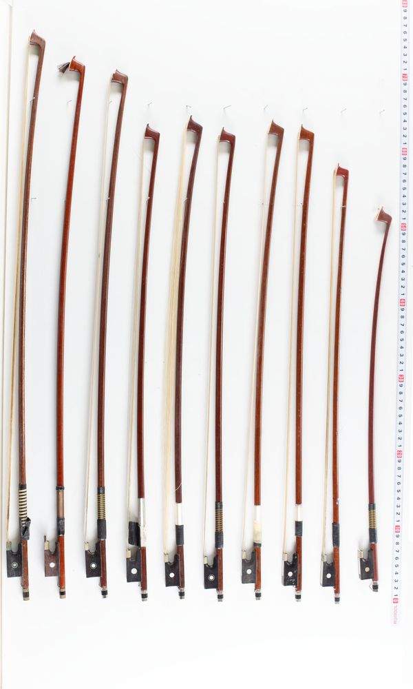 A bundle of nineteen violin bows, varying lengths