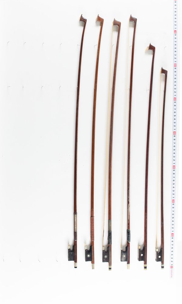 A bundle of six violin bows, varying lengths