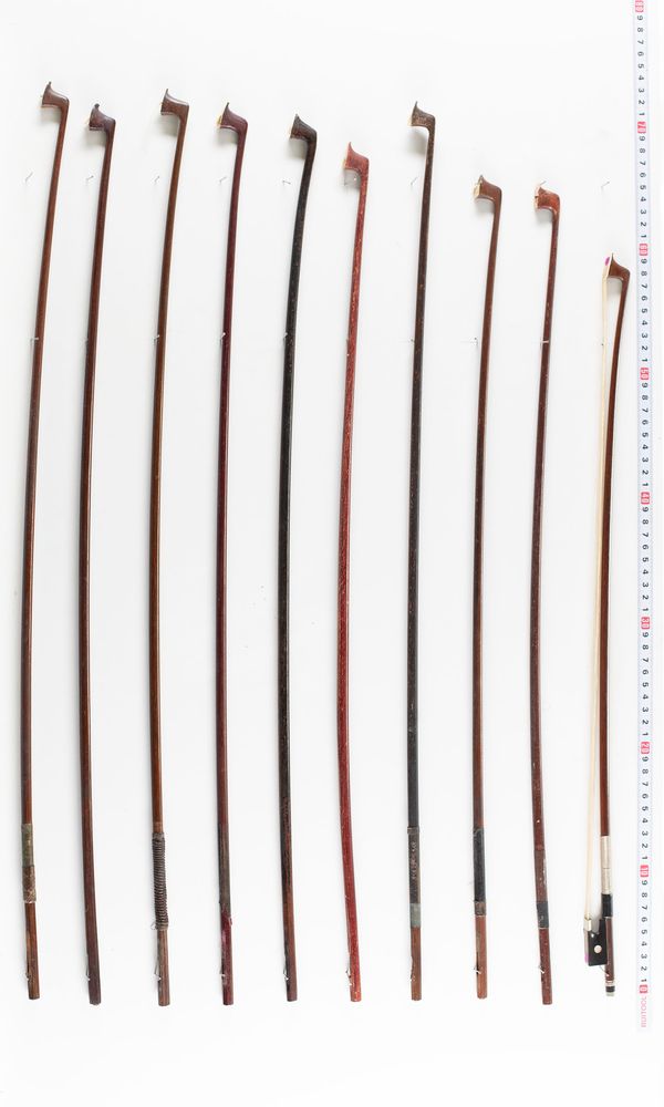 Five violin bows and eighteen bow sticks, varying lengths