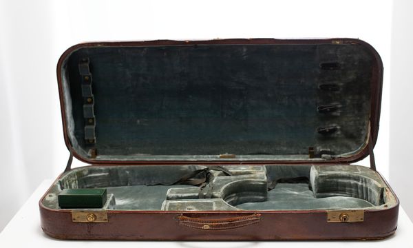 A double violin case, branded W. E. Hill & Sons